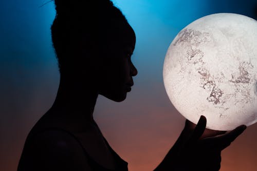Free Silhouette of Woman Holding Moon Stock Photo