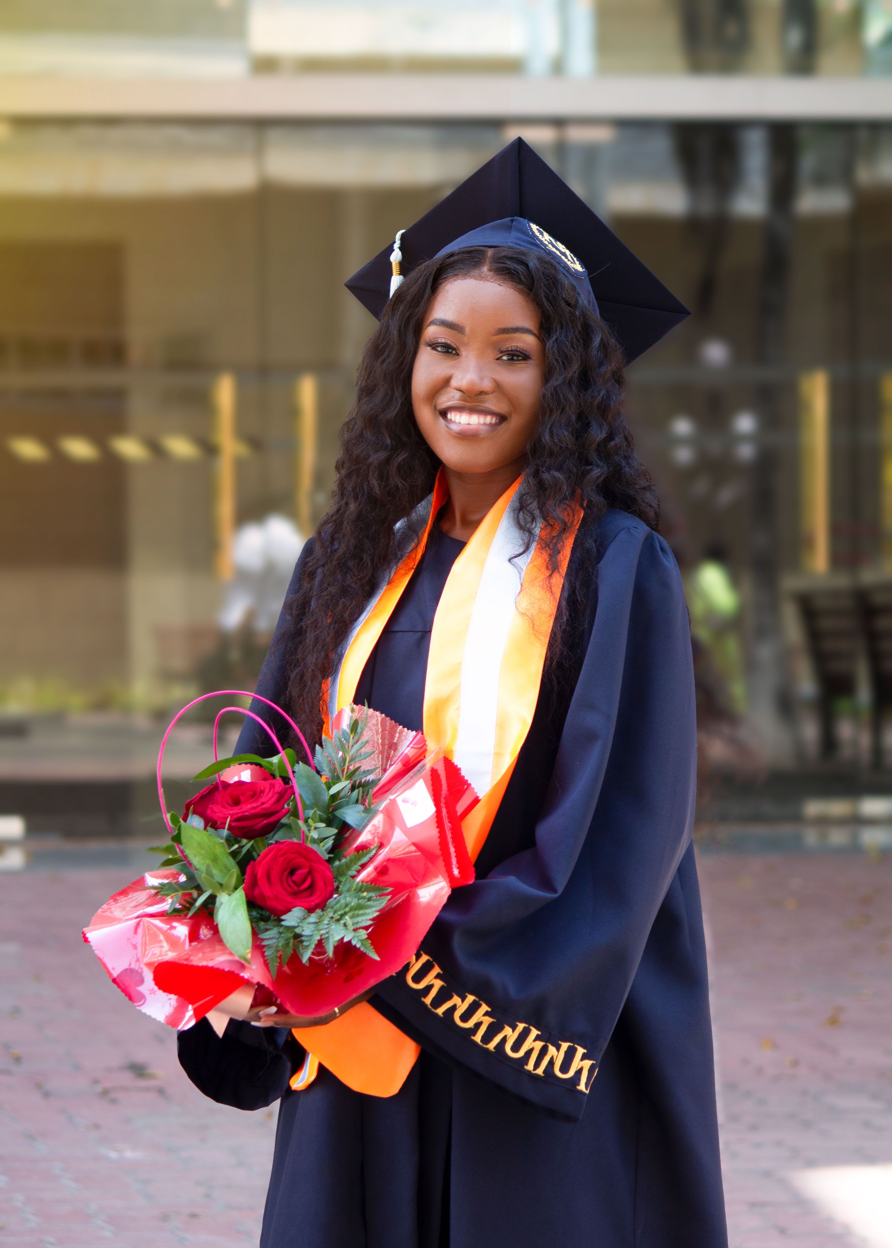 Woman in Academic Dress Holding Bouquet a of Red Roses · Free Stock Photo