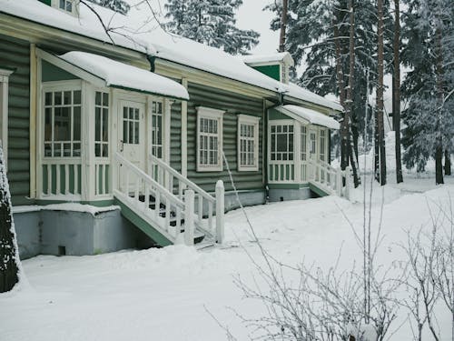 White Wooden House on Snow Covered Ground