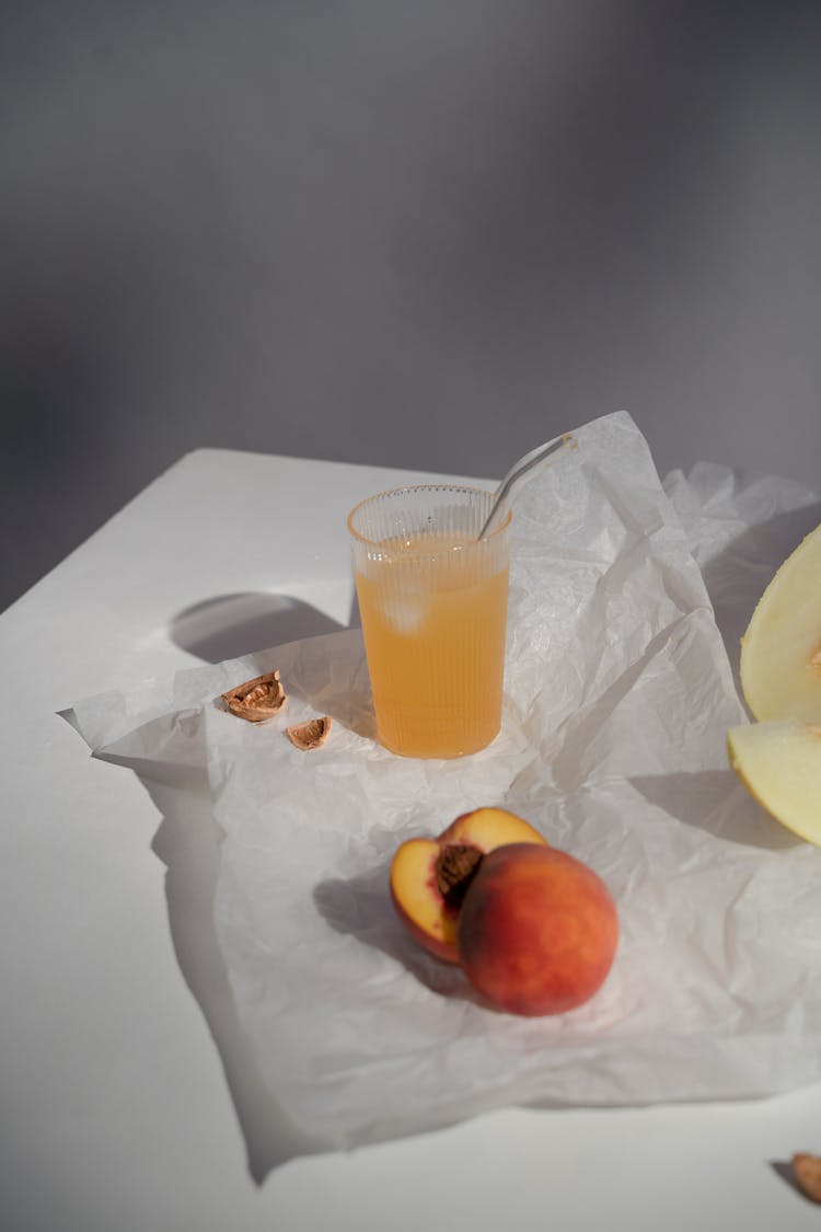 Peach And Juice With Straw On Paper