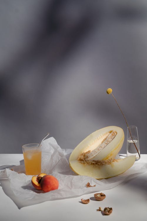 Melon and Peach near Flower and Juice with Straw