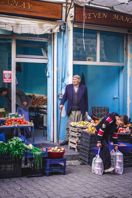 Elderly Man standing in a Store Stall 