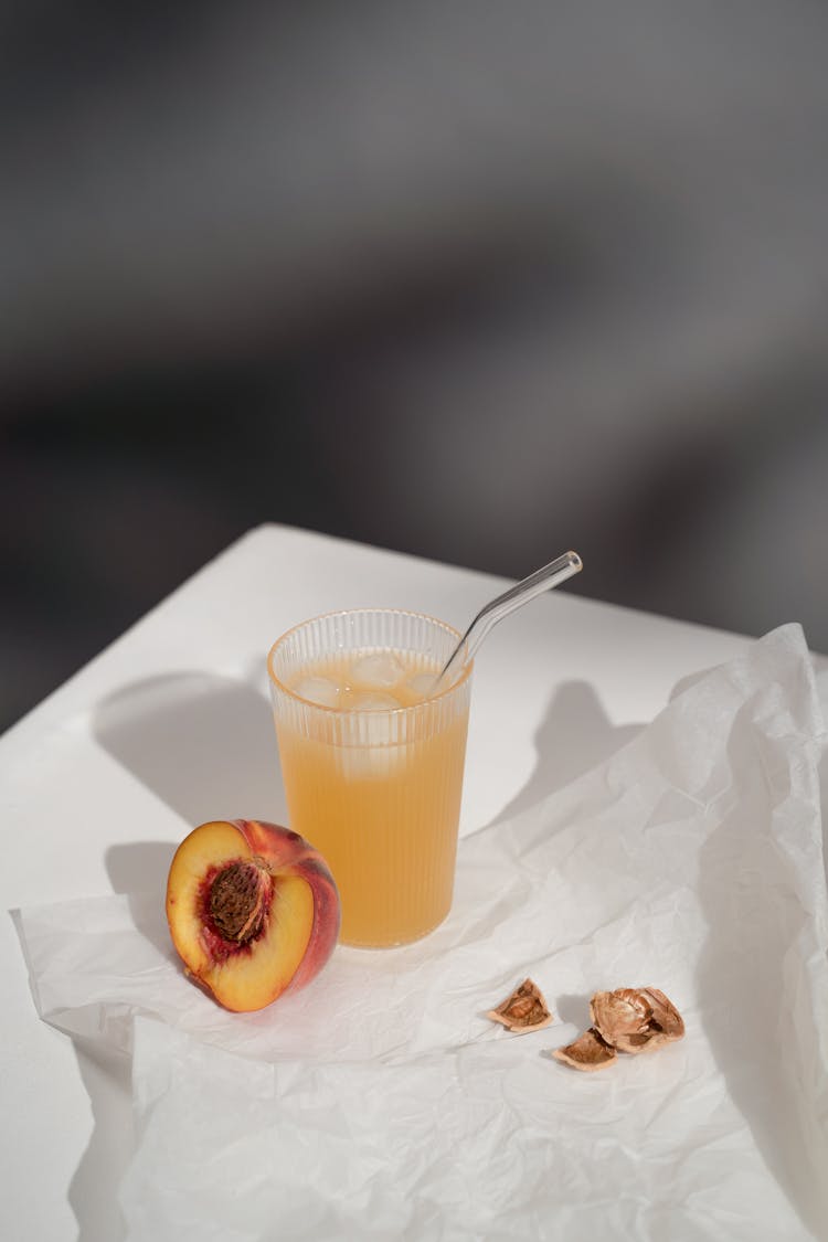 Juice With Ice And Peach On Paper