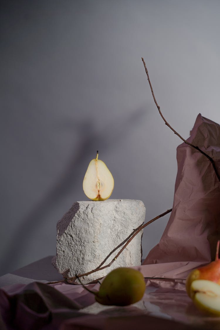 Pear On Rock On Table