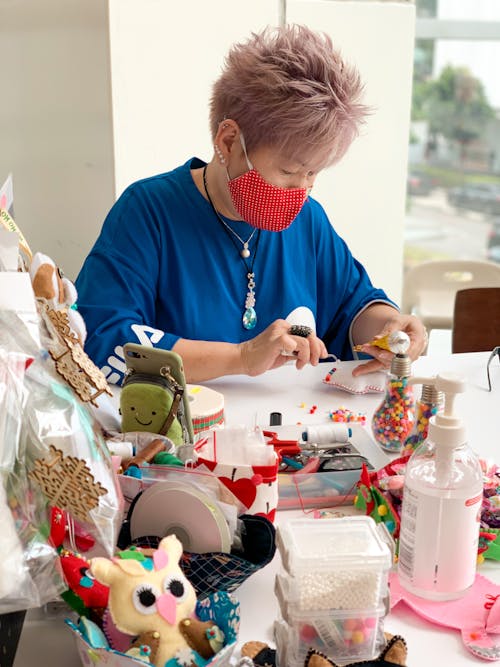 Woman with Pink Hair doing Handicrafts