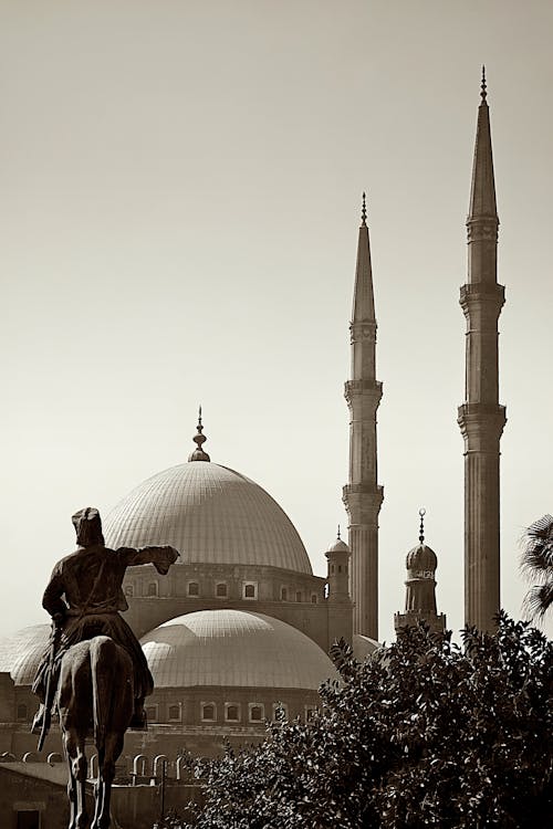 A Statue of a Man Riding a Horse with the Alabaster Mosque in Background