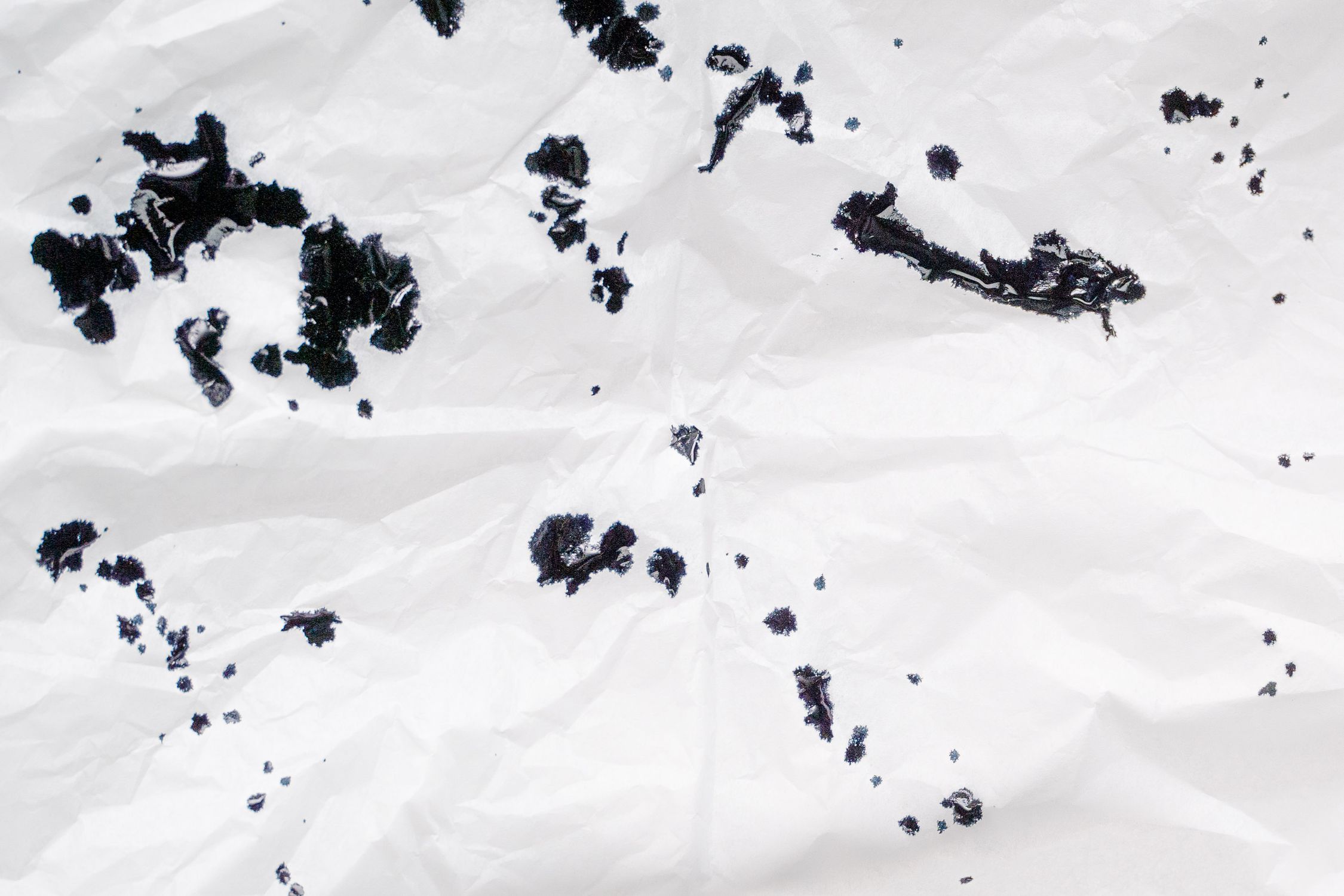 Stringy Ink Mess On Paper Ink Spots on Wrinkly Paper · Free Stock Photo