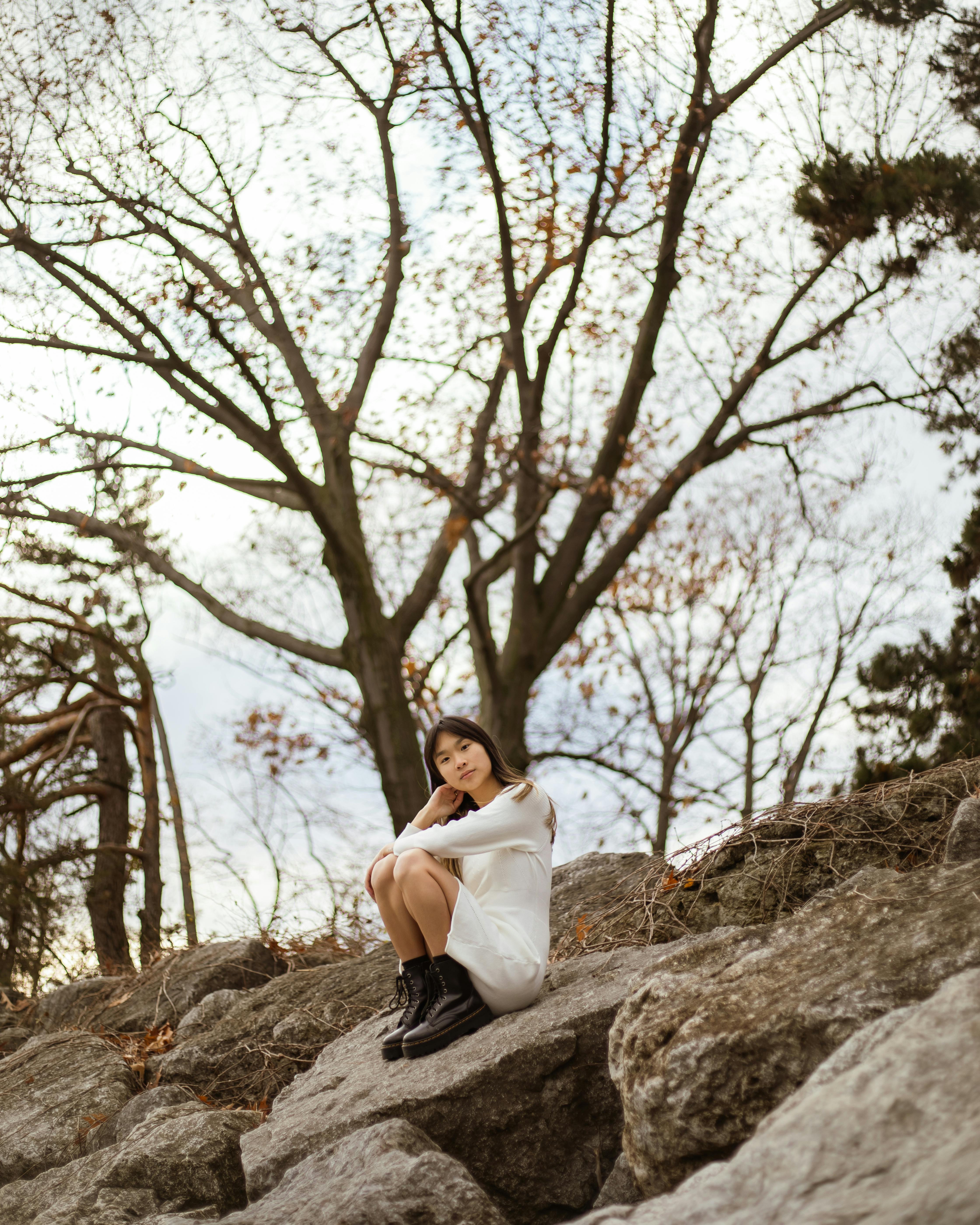 woman sitting on rock