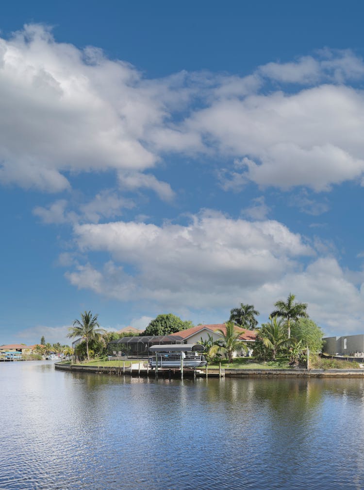 A House Beside A Lake Under Blue Sky 