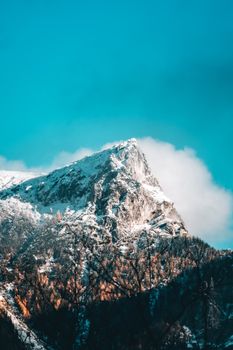 Majestic snow-capped mountain peak under a clear blue sky, perfect for nature lovers.