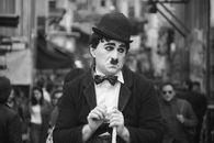 Black and White Photo of a Man Wearing a Suit and a Hat