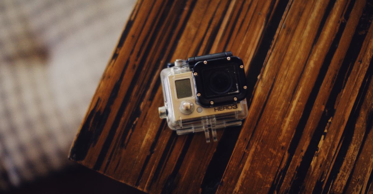 Gopro Table Close-up Photo of a GoPro HERO3 on the Wooden Table · Free Stock Photo