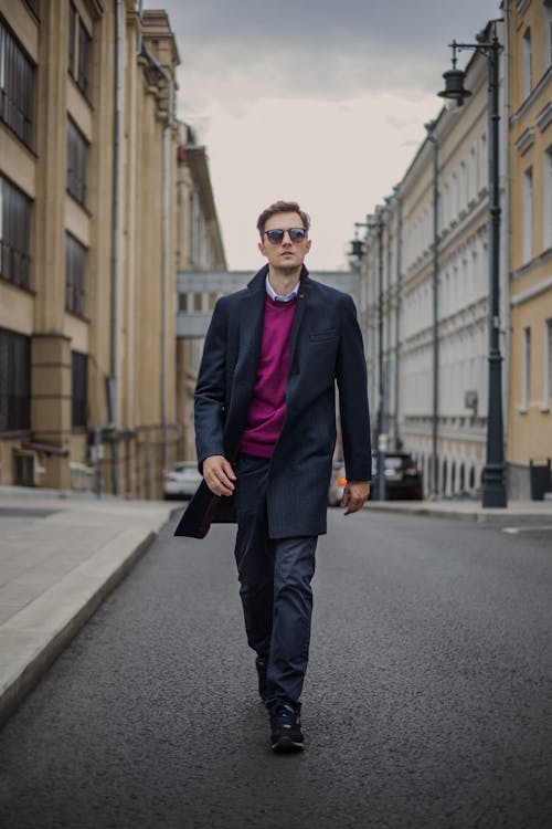 A Stylish Man Walking on the Street