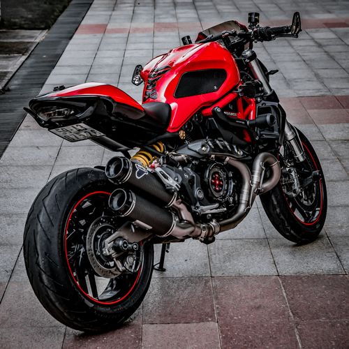 Free Vibrant red sports motorcycle parked outdoors in a city setting with sleek design elements. Stock Photo