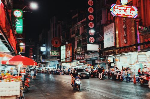 Free Explore the dynamic nightlife of an Asian city street bustling with neon lights and vibrant activity. Stock Photo