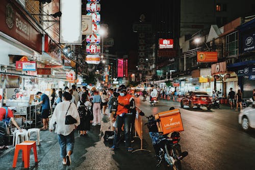 People Walking on Flea Market during Nighttime 