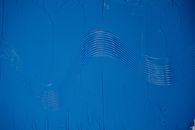 A Shot of Blue Paint With a Wavy Pattern in a Middle 