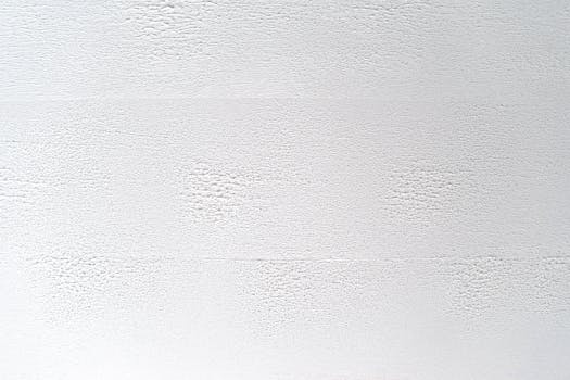 Close-up of a white textured wall, perfect for backgrounds or design elements.