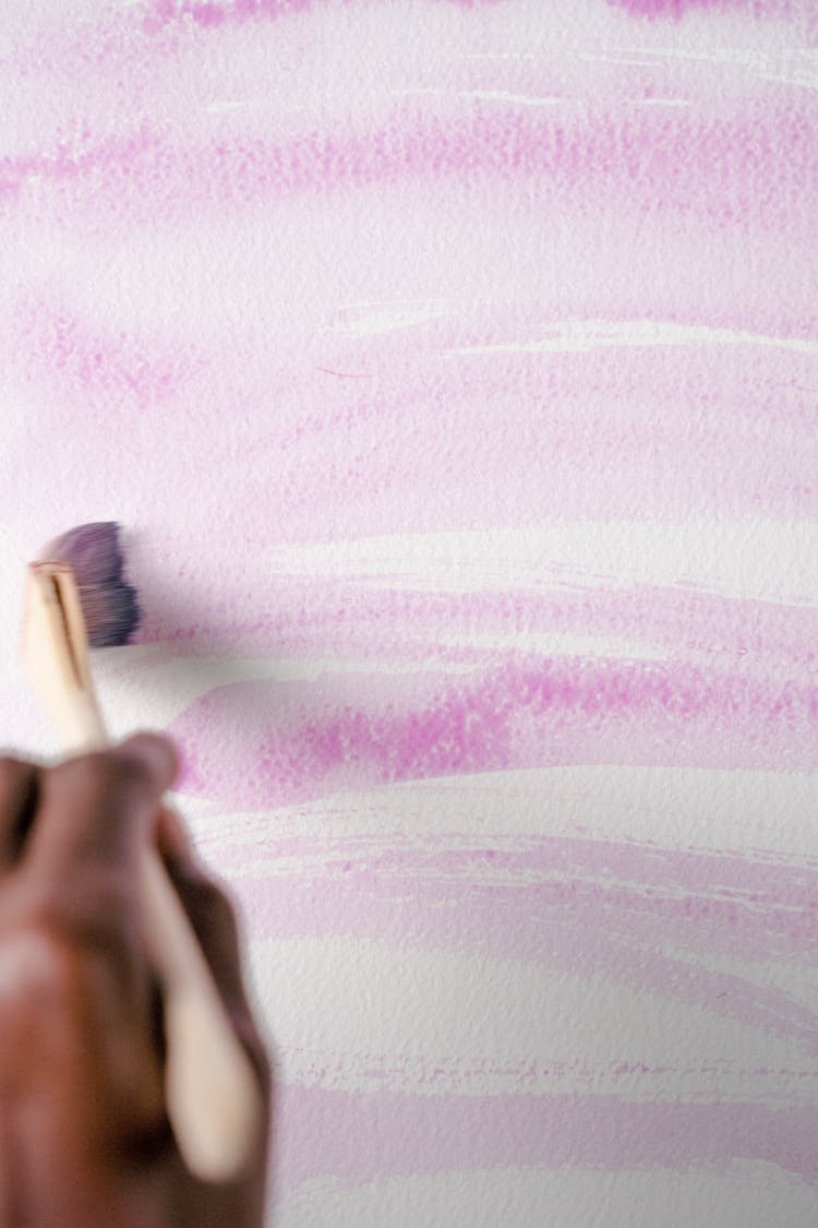 Photo Of A Person Using A Brush With Purple Water Color