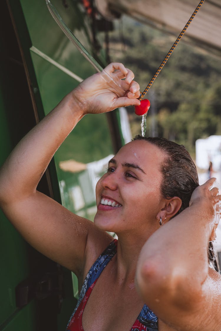 A Happy Woman Having A Shower Outdoors