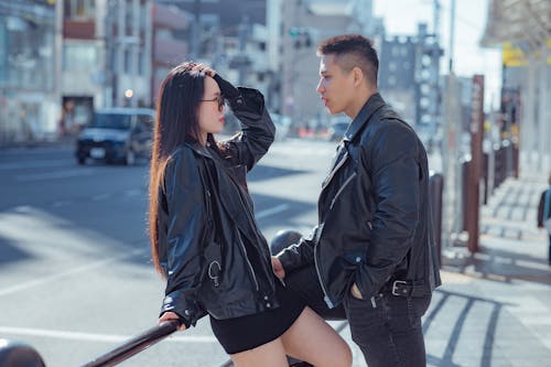 Free A Couple Standing on the Street Stock Photo