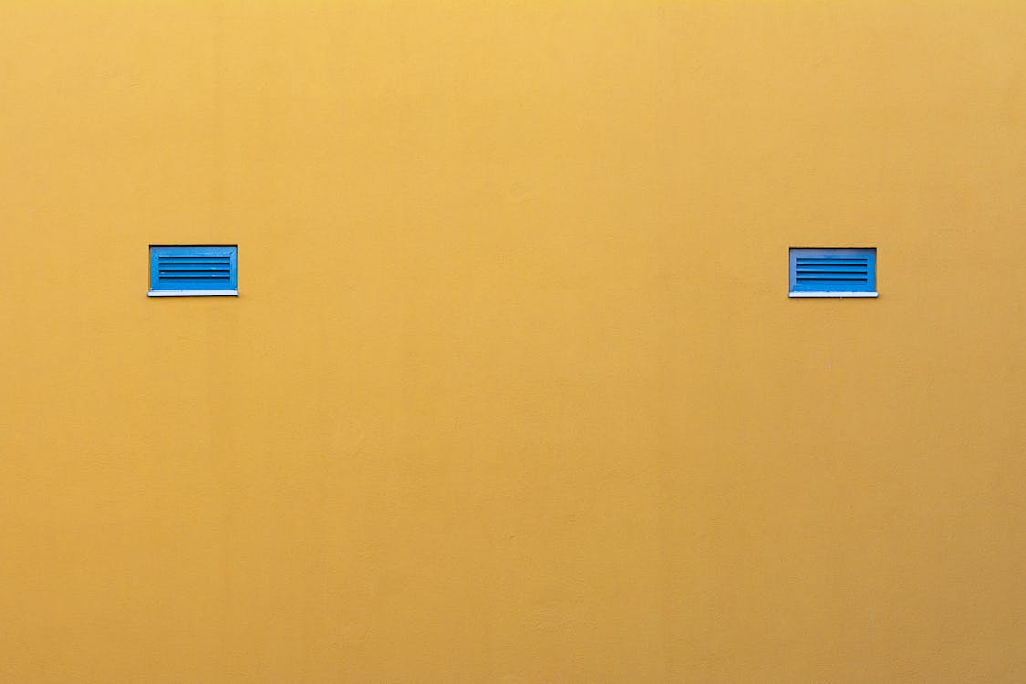 Blue Tiny Windows in a Yellow Wall 