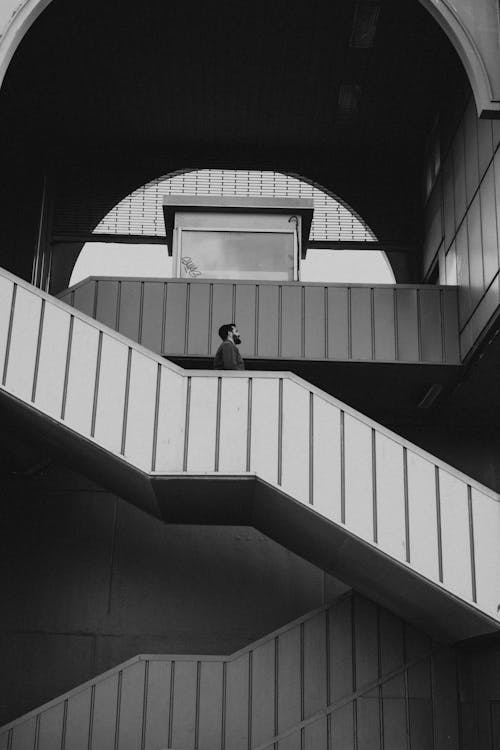 Monochrome Photo of a Man on the Stairs