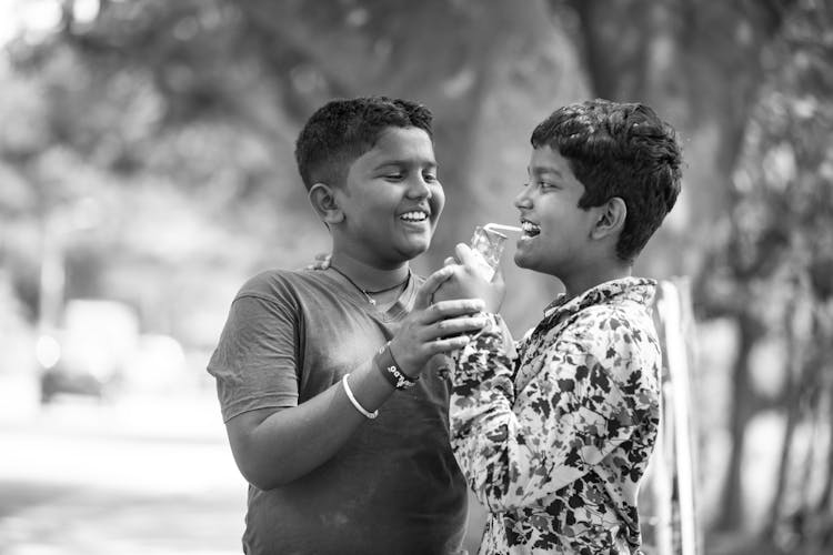 Young Boys Sharing A Drink