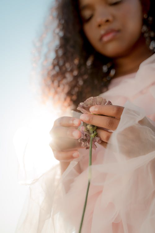 Woman in Tulle Dress Holding Carnation Flower