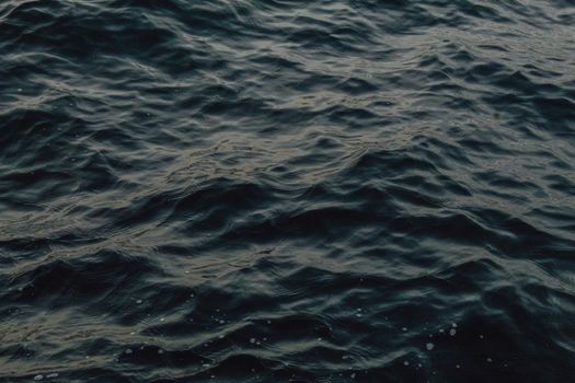 Dark blue ocean waves captured from above, showcasing a calm water surface.