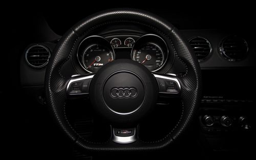 Free Close-up of an Audi car's dashboard and steering wheel, highlighting luxury design. Stock Photo