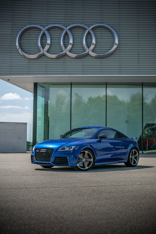 Free A Blue Audi Car Parked Outside the Audi Building Stock Photo
