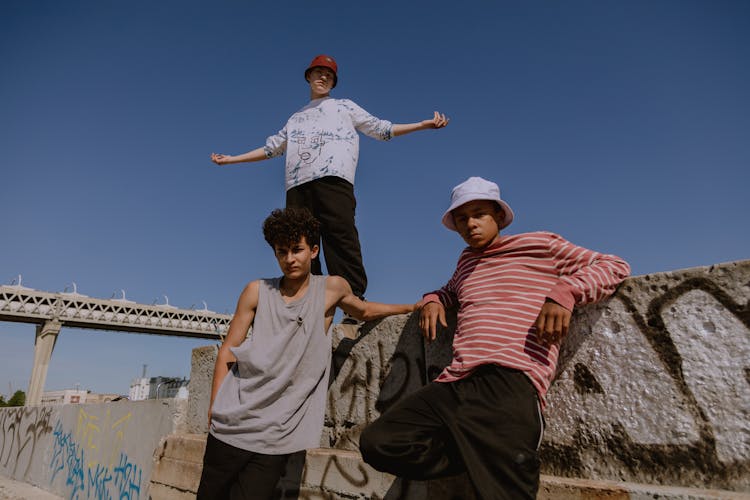 Teenage Boys Leaning On Concrete Wall