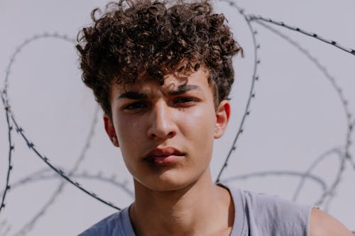 Close Up Photo of a Young Man with Curly Hair