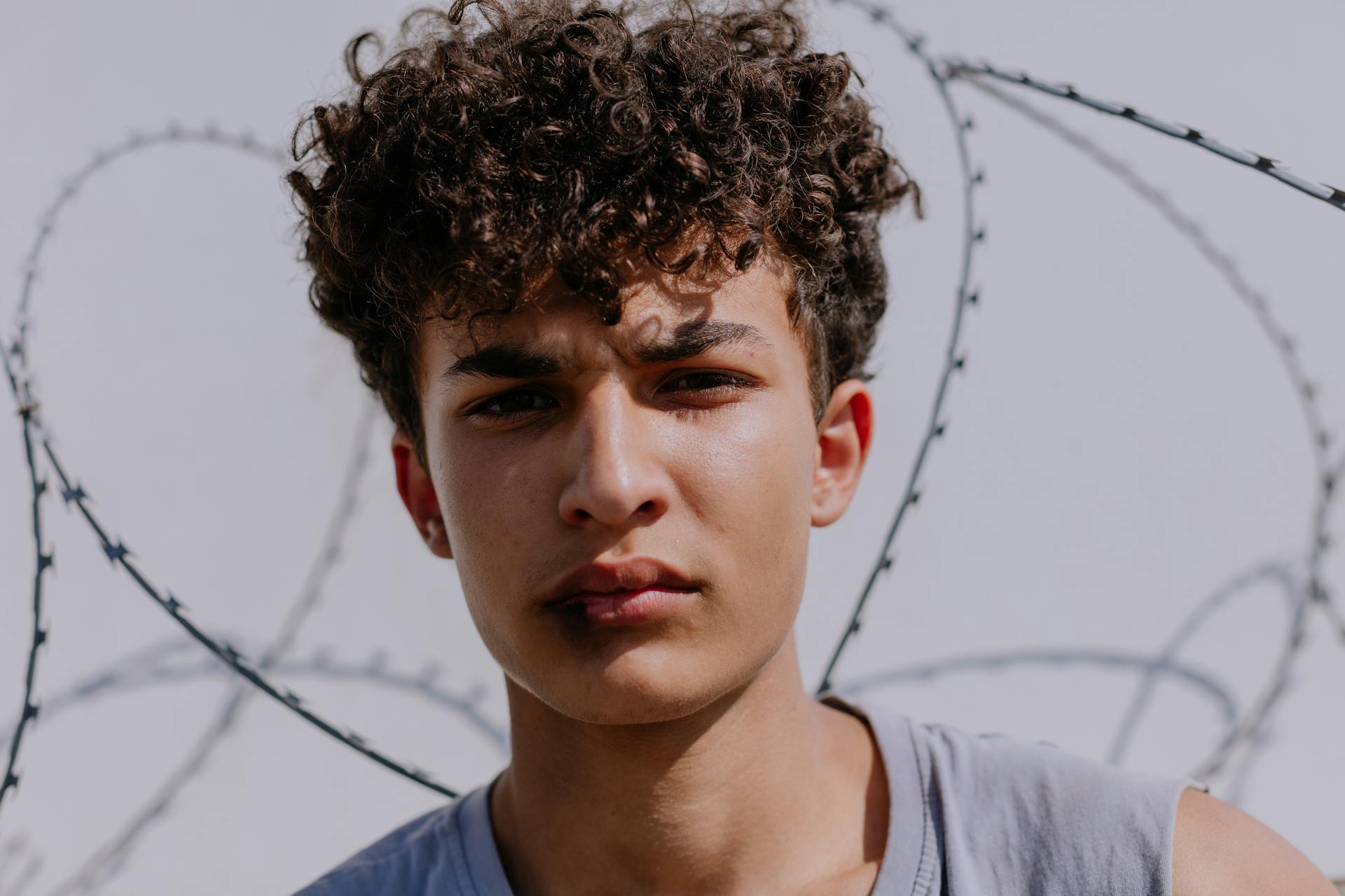 Close Up Photo of a Young Man with Curly Hair