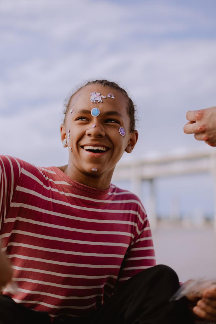 A Happy Young Man With Stickers On His Face