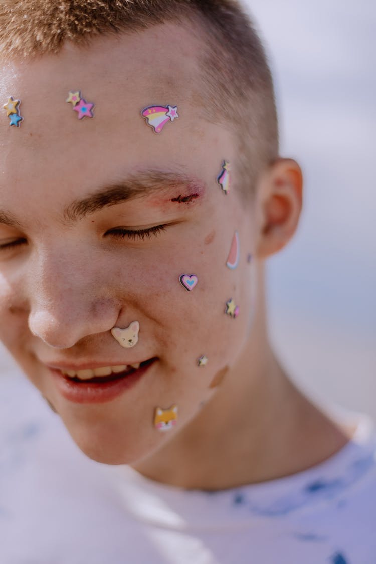 Teenage Boy With Stickers On His Face