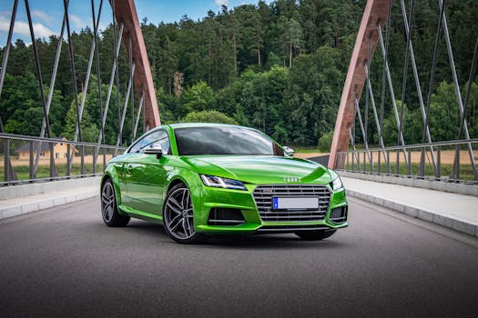 Dynamic shot of a green Audi TTS sports car on a bridge surrounded by lush greenery.