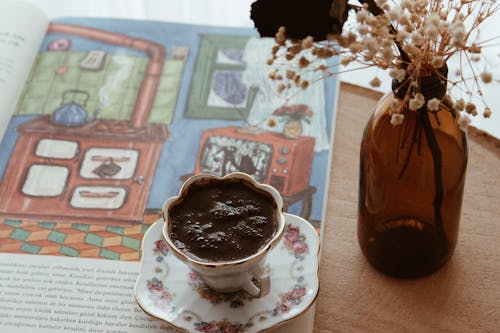 A Cup of Coffee on an Open Book