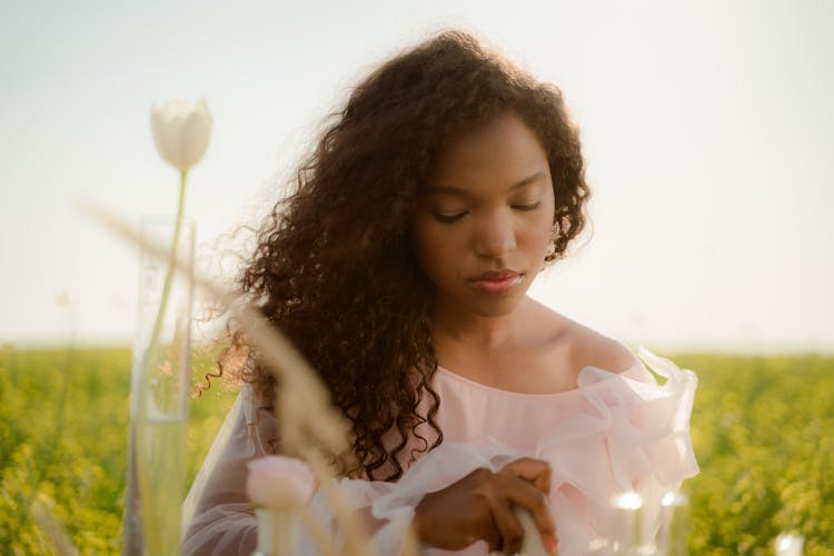 Young Woman With Long Curly Hair Creating New Natural Perfumes And Flavours