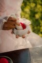 Unrecognizable Hands Beating Red Substance in Mortar with Pestle