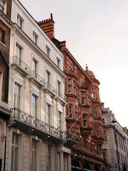 Capture of classic urban residential buildings with ornate balconies and brick facades.