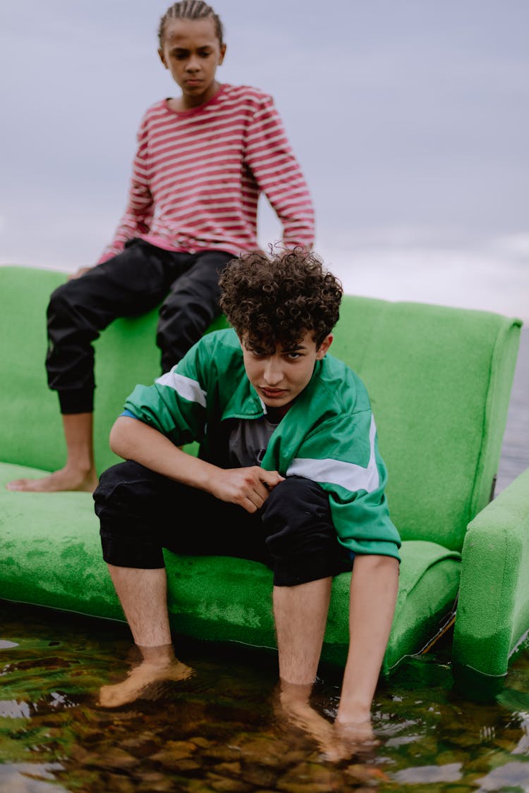 Kids Sitting On A Broken Couch
