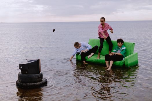 Boys Sitting on Couch over a Lake