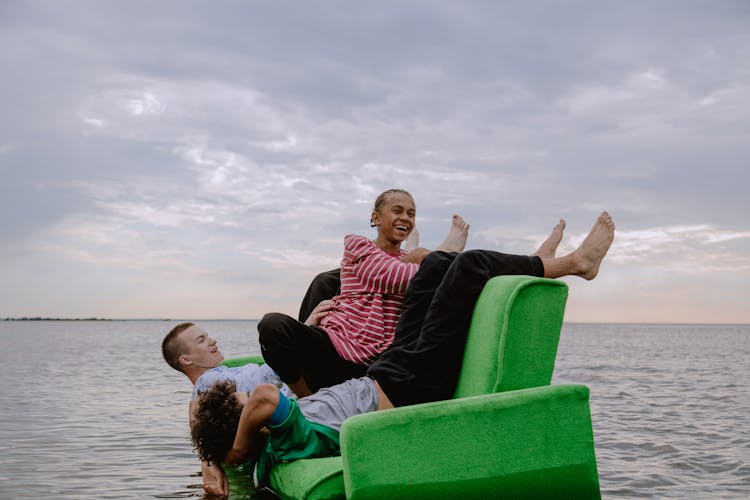 Friends Sitting On A Green Couch 