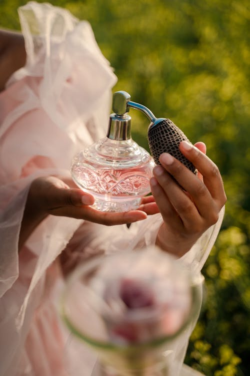 Woman Holding Perfume Bottle