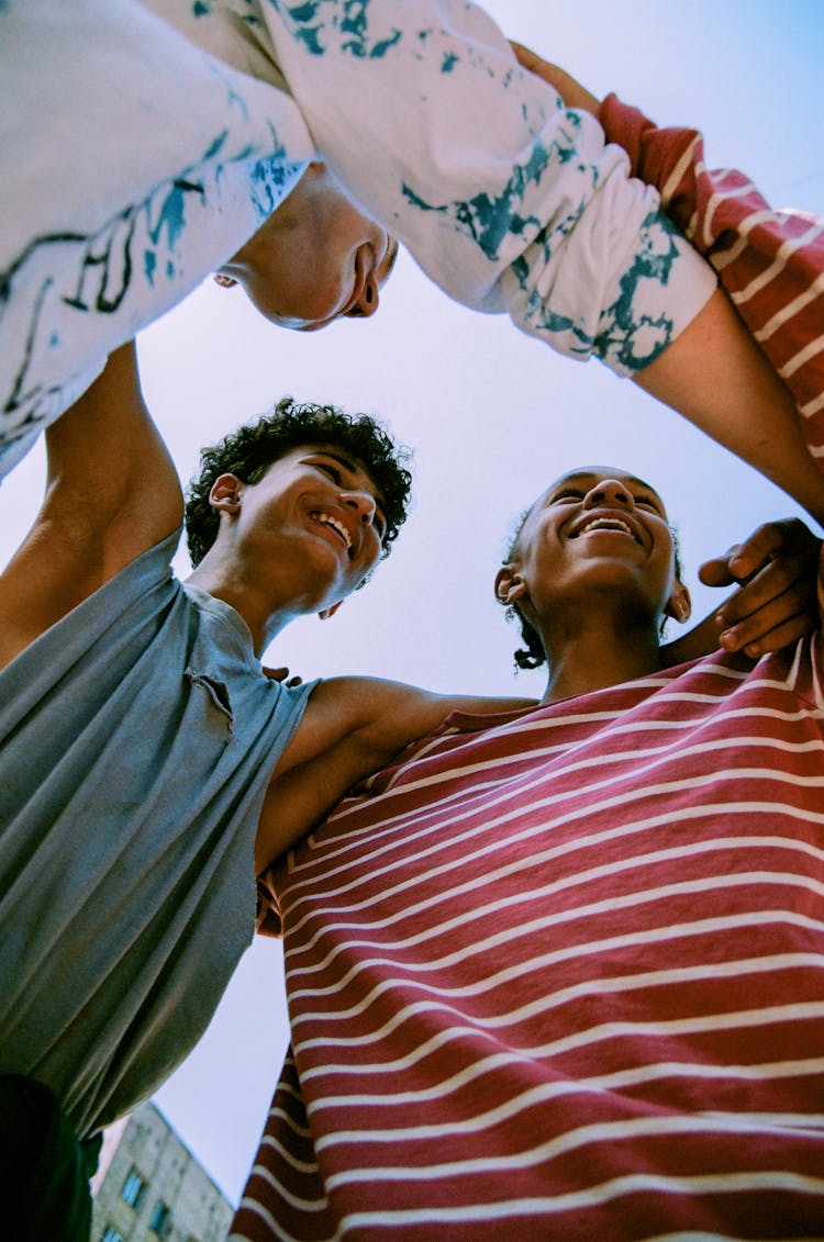 Happy Young Teenage Boys Hugging Each Other