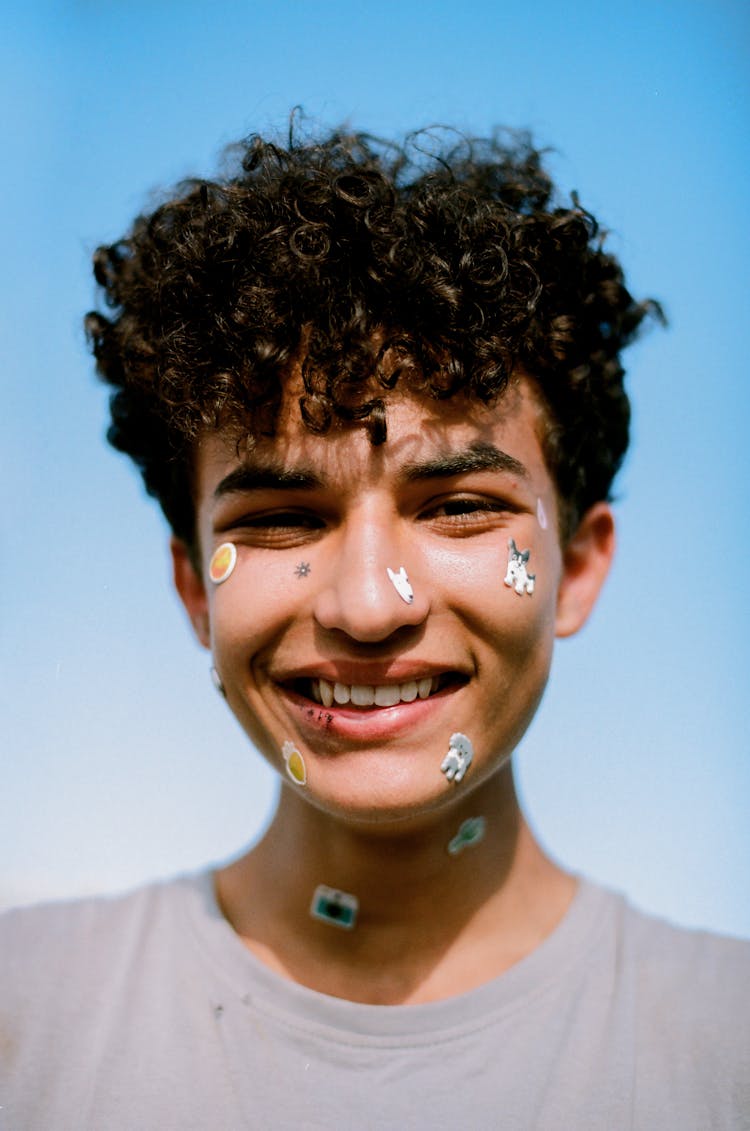 A Man With Stickers On His Face 