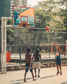 Youth playing basketball on a sunny day in Rio, showcasing team spirit and outdoor sports.