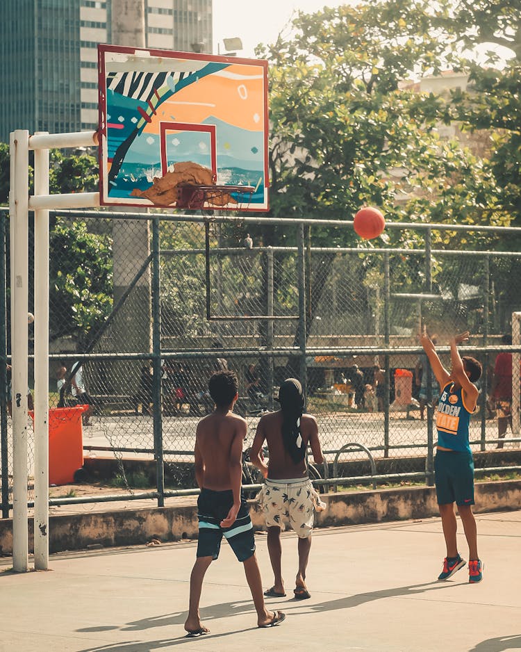 A Group Of Men Playing Basketball